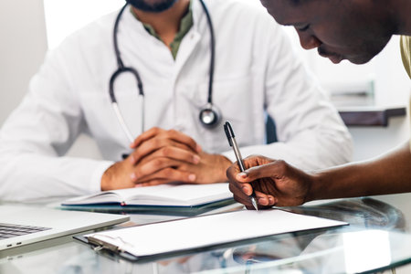 doctor and male patient talking at office consultation for further treatmentの写真素材