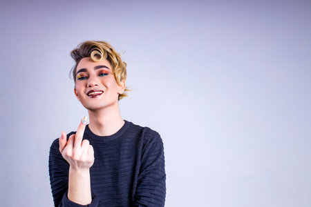 body positive i love myself man with gorgeous make up and hairstyle in studio white backgroundの写真素材