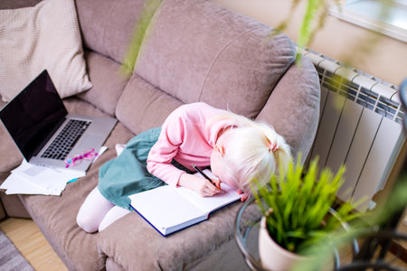girl getting online lesson at home, social distance during quarantine aloneの写真素材