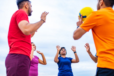 multiethnic team group playing beach volley on sun light