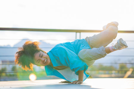 multiracial curly woman enjoying dance at sunset in beachの写真素材