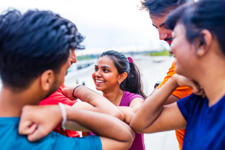 four indian people warming up outdoors in sport wear morning time urbanの写真素材