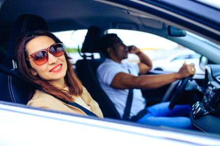 brunette middle age student woman in new car outdoor summer dayの写真素材