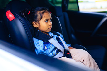 multicultural race baby girl in car seat with fastened beltの写真素材