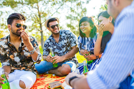 indian students having a lunch in Delhi park outdoorsの写真素材