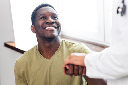 Friendly doctor hands holding patient hand support and hope conceptの写真素材