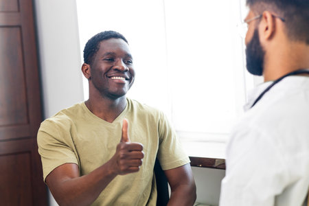 Friendly doctor hands holding patient hand support and hope conceptの写真素材