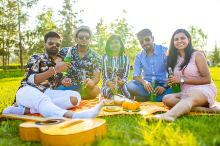 indian students having a lunch in Delhi park outdoorsの写真素材