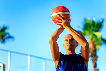 Arabic man athlete man playing basketball outdoorsの写真素材
