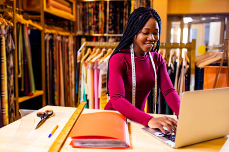 dark skinned business woman salewoman working at textile shopの写真素材