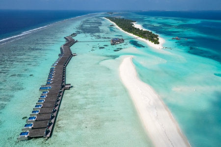 stunning blue ocean and sandy lux hotels on water top drone aeral view Maldives beach copyspace for textの写真素材