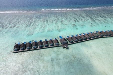 stunning blue ocean and sandy lux hotels on water top drone aeral view Maldives beach copyspace for textの写真素材
