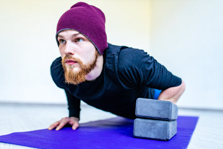handsome man warm up and stay strong at home workoutの写真素材