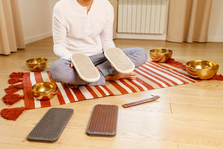 morning yoga practice with sadhu nails. mans foot on the wooden desk with sharp metal nailsの写真素材