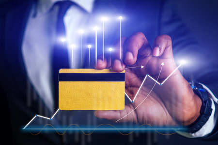 A man holding a credit card with a black stripe and a yellow stripeの写真素材