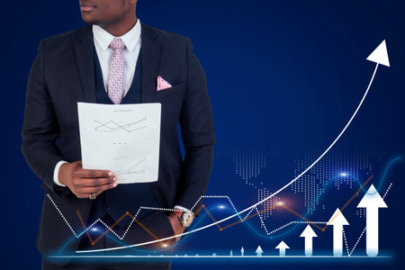 A man in a suit holding a piece of paper with a graph on it