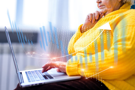 A woman is sitting in front of a laptop, typing on the keyboardの写真素材