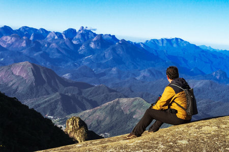 Mountaineer contemplating mountain rangeの写真素材