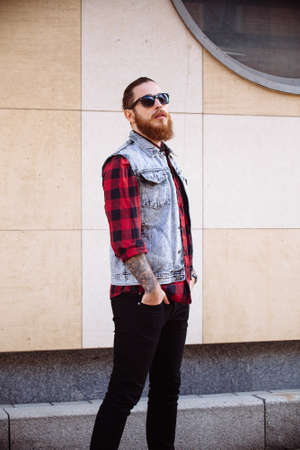 Bearded hipster wearing sunglasses in the city outdoorの写真素材