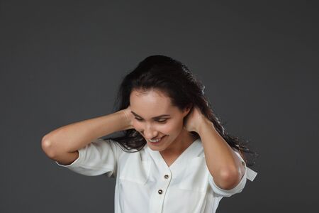 beautiful young women posing in studio on grey backgroundの写真素材