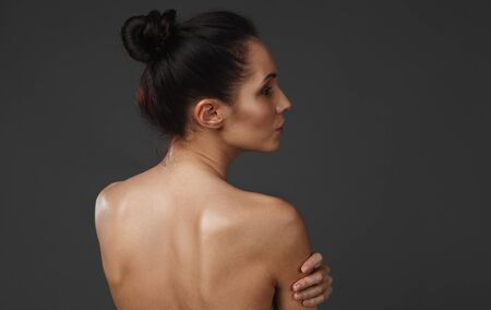 beautiful young woman with healthy face and clean skin on black backgroundの写真素材