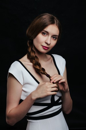 beautiful young women posing in studio on black backgroundの写真素材