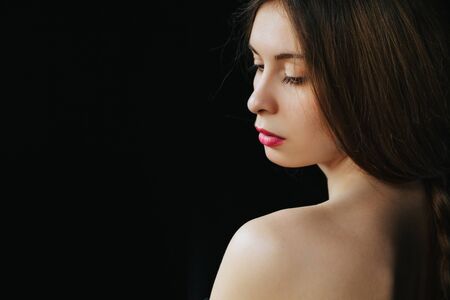 beautiful young women posing in studio on black backgroundの写真素材