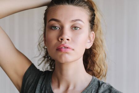 Portrait close up of young beautiful woman in studio
