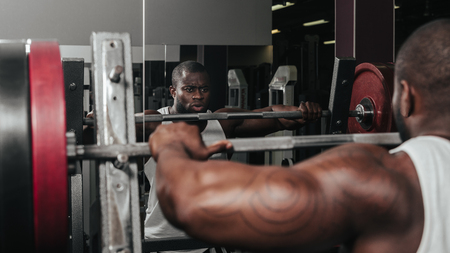 Weight training African doing bodybuilding in gymの写真素材