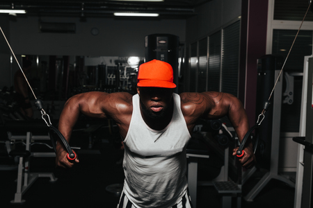 Weight training African doing bodybuilding in gymの写真素材