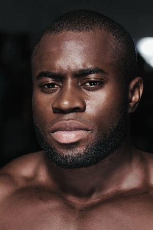 Weight training African bodybuilder portrait in gymの写真素材