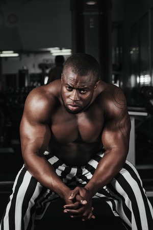 Weight training African doing bodybuilding in gymの写真素材