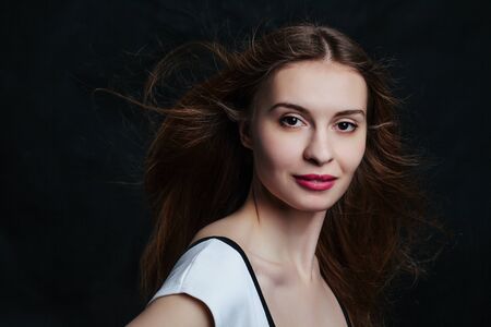 beautiful young women posing in studio on black backgroundの写真素材