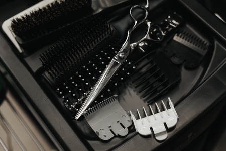 Professional hairdresser tools, combs, scissors on plastic tableの写真素材