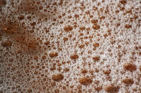 Texture of wet sand and ocean bubblesの写真素材