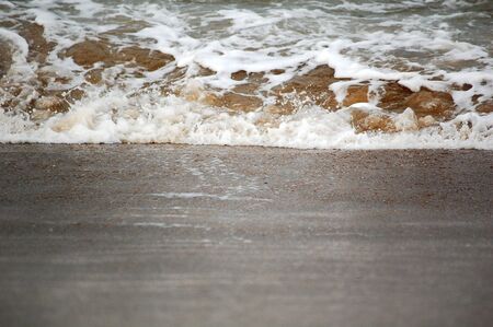 A small wave splash on the beach sandの写真素材