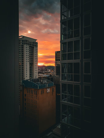 Sunset in the city. View from the window of a skyscraper.の写真素材