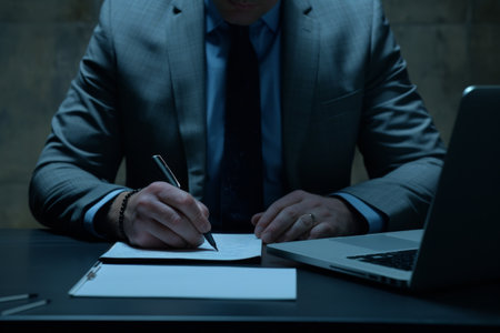 Close up hands of Businessman signing a document on desk, office background, Business concept.の素材