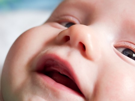 amused happy European little baby face close-up