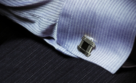 hand of a man in a shirt with cuff link