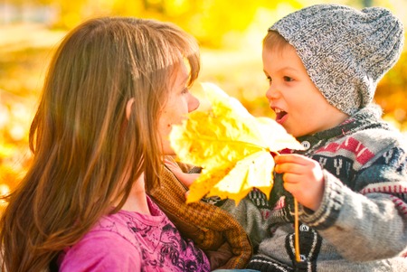 Happy family relaxing outdoors In autumn parkの写真素材
