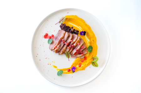 Duck fillet with sweet potato puree and lingonberries. High quality photoの写真素材