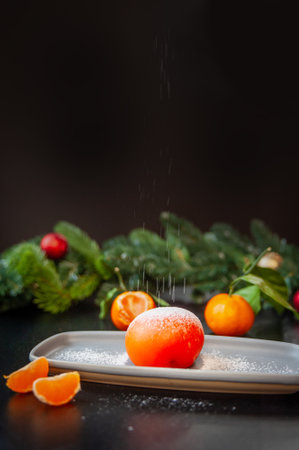 Plate with delicious mochi and tangerine on a dark background. High quality photoの写真素材