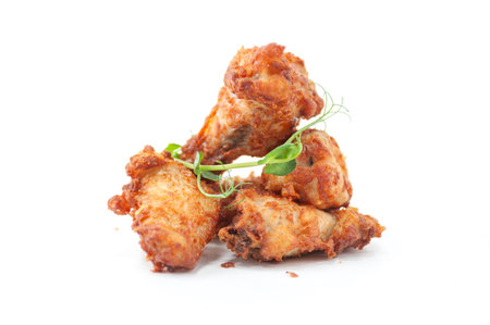 Golden Fried Chicken Wings with Fresh Microgreensの写真素材