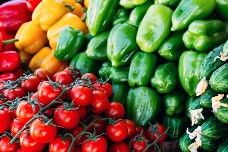 Pile of cherry tomatoes and bell peppers nicely arranged at Farmer's marketの写真素材