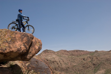 Bicyclist stands on the brink of breakage and looks downwardsの写真素材