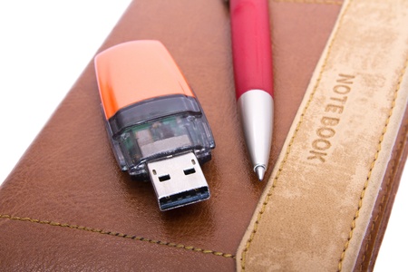 USB Flash Drive, pen and notebook close up