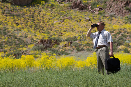 business man with binoculars looking to the future, horizontal frame の写真素材