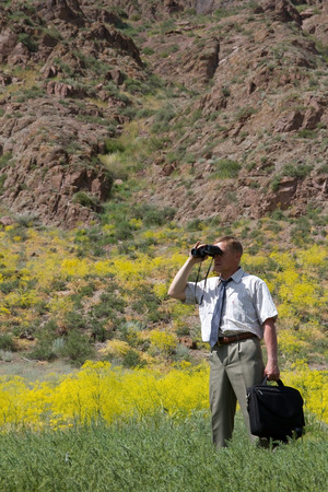 business man with binoculars looking to the future, vertical frameの写真素材