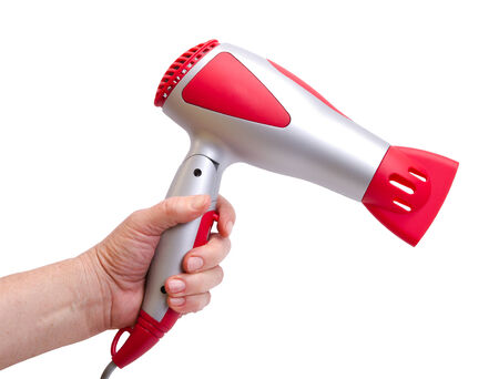hand with the hair dryer on a white backgroundの写真素材